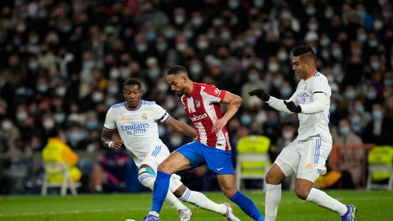 Atletico Madrid's Matheus Cunha, center, challenges for the ball with Real Madrid's David Alaba, left, and Casemiro during the Spanish League soccer match between Real Madrid and Atletico Madrid at the Santiago Bernabéu stadium in Madrid, Spain , Sunday, December 12, 2021. (AP Photo/Bernat Armangue)