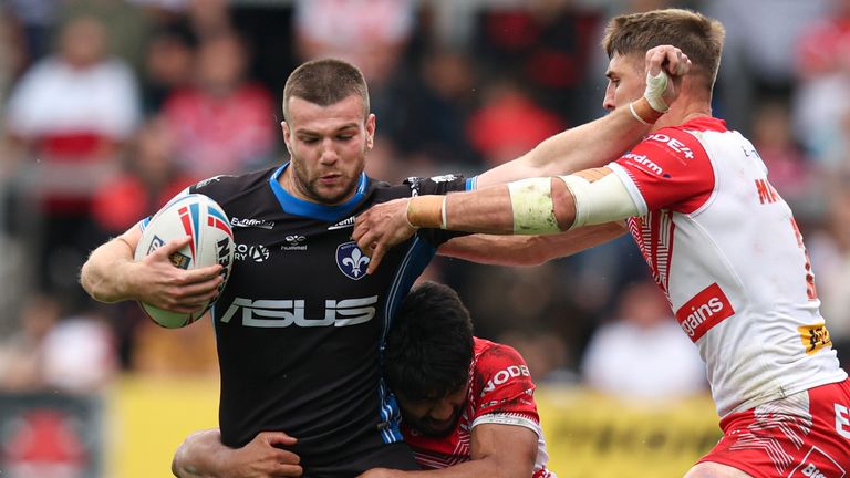 Wakefield's Max Jowitt is tackled by St Helens' James Bell and Tommy Makinson