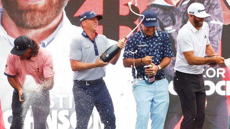 BEDMINSTER, NJ - JULY 31: The 4 Aces Team of Pat Perez, Talor Gooch, Patrick Reed and Dustin Johnson spray champagne after winning the team competition at the LIV Golf Invitational Series Bedminster on July 31, 2022 at Trump National Golf Club in Bedminster, New Jersey. (Photo by Rich Graessle/Icon Sportswire) (Icon Sportswire via AP Images)