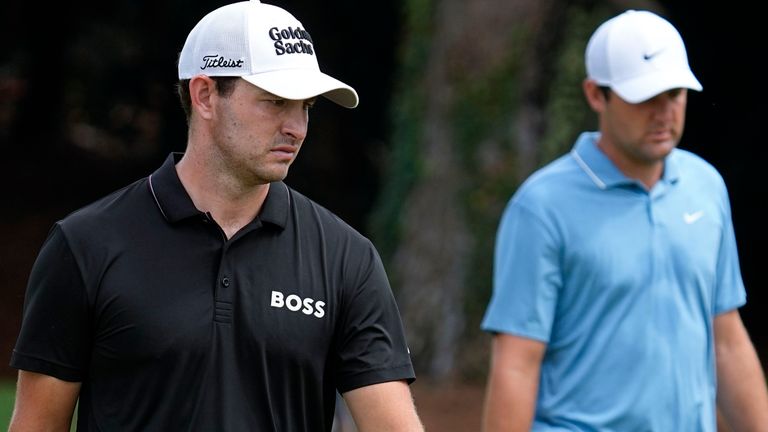 Patrick Cantlay, left, and Scottie Scheffler walks up the seventh fairway during the first round of the Tour Championship golf tournament at East Lake Golf Club, Thursday, Aug. 25, 2022, in Atlanta. (AP Photo/Steve Helber)