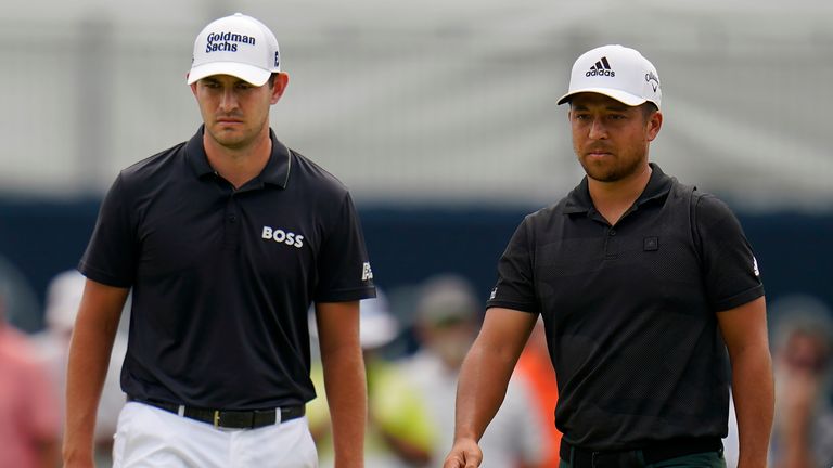 Patrick Cantlay, left, and Xander Schauffele walk on the first green during the final round of the BMW Championship golf tournament at Wilmington Country Club, Sunday, Aug. 21, 2022, in Wilmington, Del. (AP Photo/Julio Cortez)