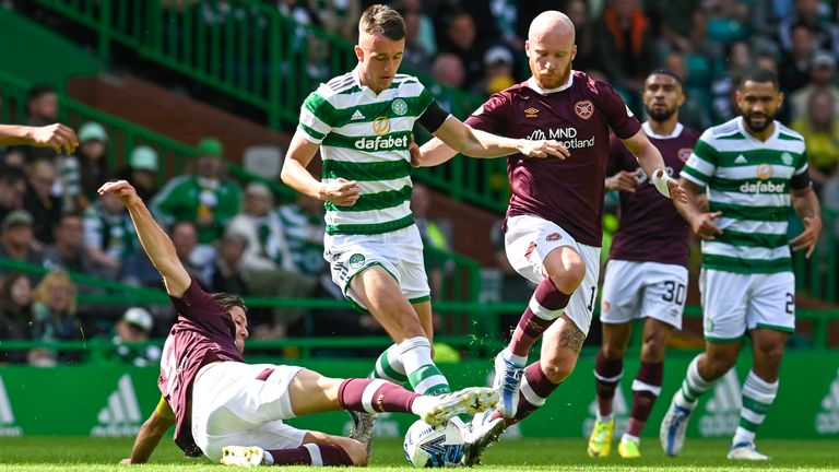 Peter Haring (L) and David Turnbull in action during a cinch Premiership match between Celtic and Hearts at Celtic Park