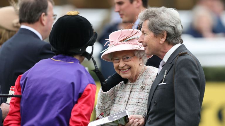 Her Majesty The Queen talks to jockey Ryan Moore in the parade ring