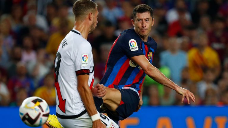 Lewandowski, right, shoots past Rayo's Florian Lejeune