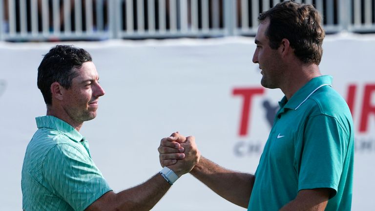 Rory McIlroy, of Northern Ireland, left and Scottie Scheffler speak after their round on the 18th green during the final round of the Tour Championship golf tournament at East Lake Golf Club, Sunday, Aug. 28, 2022, in Atlanta. (AP Photo/Steve Helber)