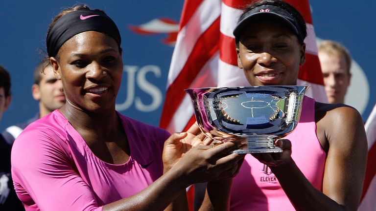 Serena Williams, left, of the United States, and her sister Venus lifting the US Open Doubles trophy in 2009