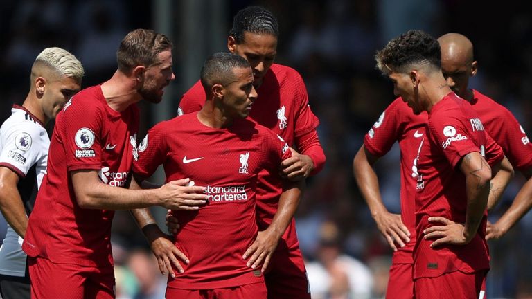 Liverpool's Thiago talks with team-mates after pulling up with an injury (AP)