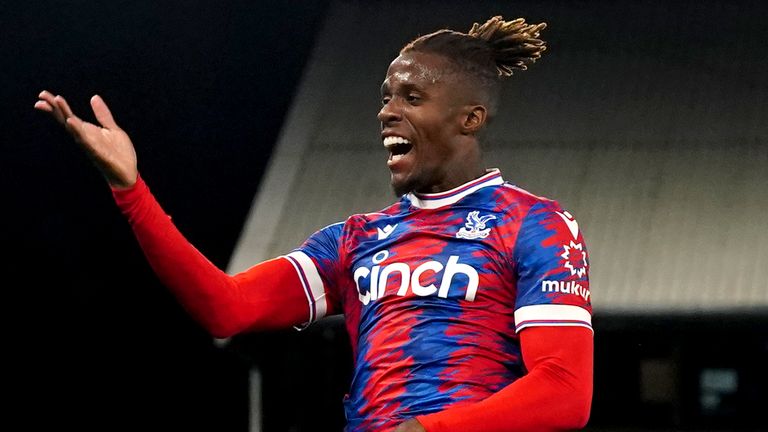 Wilfried Zaha leaps in celebration after scoring against Brentford
