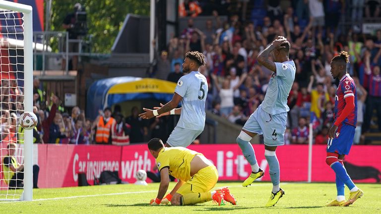 Wilfried Zaha slots the rebound past Emi Martinez after missing his penalty