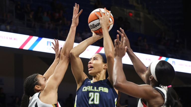 Dallas Wings forward Isabelle Harrison (20) shoots from between Las Vegas Aces center Kiah Stokes (41) and guard Jackie Young (0) during the first half of a WNBA basketball game Thursday, Aug. 4, 2022, in Arlington, Texas. (Rebecca Slezak/The Dallas Morning News via AP)


