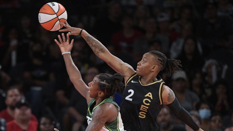 Las Vegas Aces guard Riquna Williams (2) blocks a shot by Seattle Storm guard Jewell Loyd during the first half of a WNBA basketball game Sunday, Aug. 14, 2022, in Las Vegas.