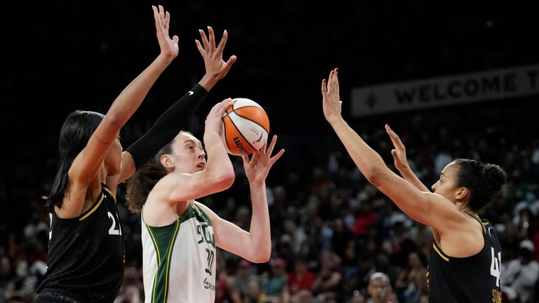 Seattle Storm forward Breanna Stewart shoots against Las Vegas Aces forward A&#39;ja Wilson, let, and center Kiah Stokes, right, during the second half in Game 1 of a WNBA basketball semifinal playoff series Sunday, Aug. 28, 2022, in Las Vegas.