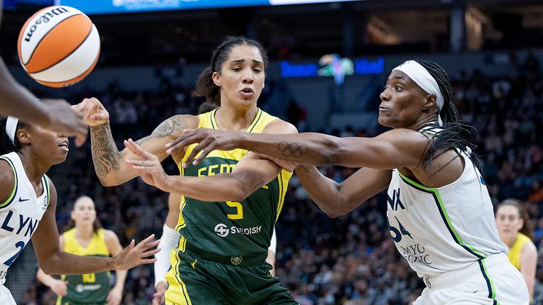 Minnesota Lynx center Sylvia Fowles (34) battles for the ball with Seattle Storm forward Gabby Williams (5) during the second quarter of a WNBA basketball game Friday, Aug. 12, 2022, in Minneapolis.