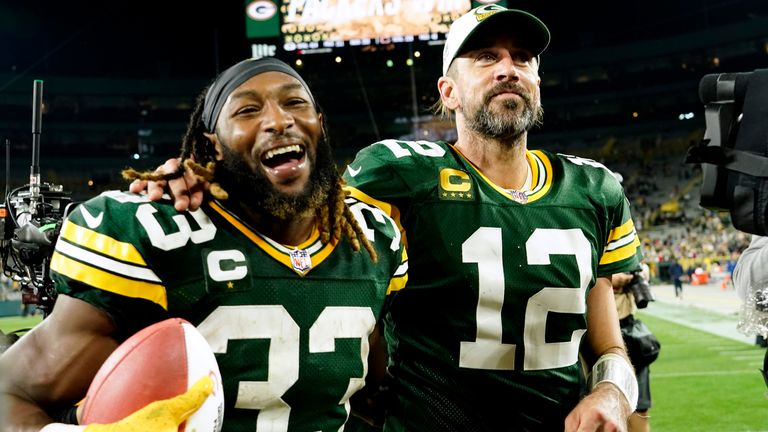 Green Bay Packers running back Aaron Jones (33) walks off the field with teammate quarterback Aaron Rodgers (12) after an NFL football game against the Chicago Bears Sunday, Sept. 18, 2022, in Green Bay, Wis. The Packers won 27-10. (AP Photo/Morry Gash)