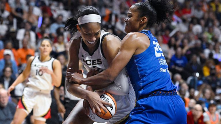 Las Vegas Aces' A'ja Wilson, left, is pressured by Connecticut Sun's Alyssa Thomas, right, during the first half in Game 4 of a WNBA basketball final playoff series, Sunday, Sept. 18, 2022, in Uncasville, Conn. (AP Photo/Jessica Hill)