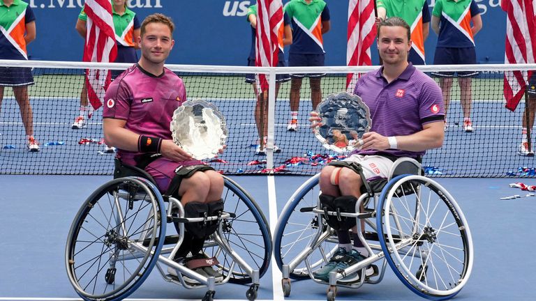 Alfie Hewett and Gordon Reid pose for a photo with their trophies after a men's wheelchair doubles championship match at the 2022 US Open on Saturday, September 10, 2022 in Flushing, New York.  (Garrett Ellwood/USTA via AP)