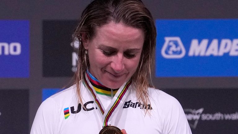 Annemiek van Vleuten looks at her gold medal after winning the race