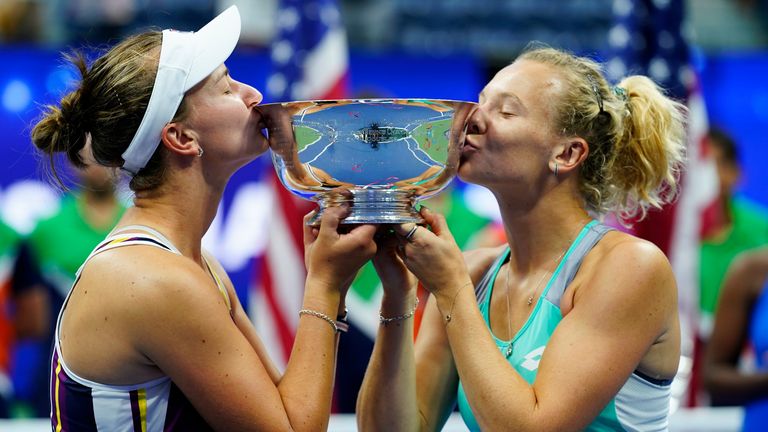 Barbora Krejcikova, of the Czech Republic, left, and Katerina Siniakova, of the Czech Republic kiss up the trophy after defeating Taylor Townsend, of the United States, and Caty McNally, of the United States, in the final of the women's doubles at the U.S. Open tennis championships, Sunday, Sept. 11, 2022, in New York. (AP Photo/Matt Rourke)
