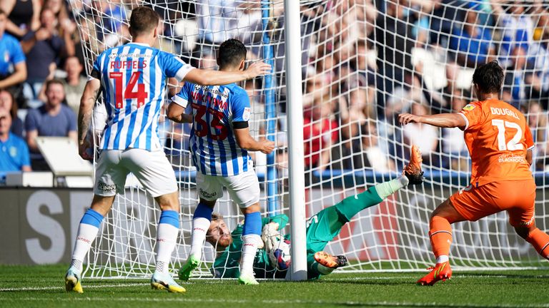Blackpool goalkeeper Daniel Grimshaw makes a double save to deny Huddersfield Town's Yuta Nakayama