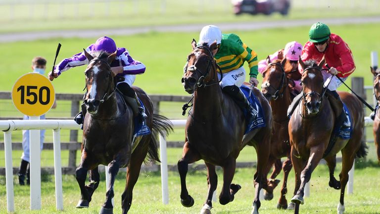 Bluegrass (purple) fights for victory at Curragh
