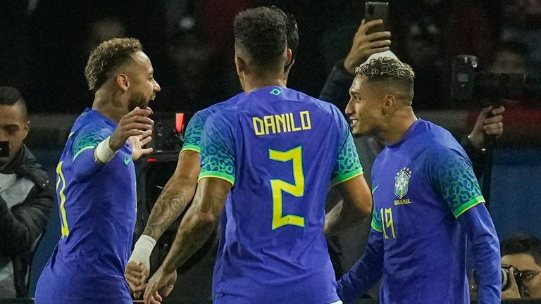 Brazil&#39;s Neymar, second left, is congratulated by teammates after scoring a penalty during the international friendly soccer match between Brazil and Tunisia at the Parc des Princes stadium in Paris, France, Tuesday, Sept. 27, 2022. (AP Photo/Christophe Ena)