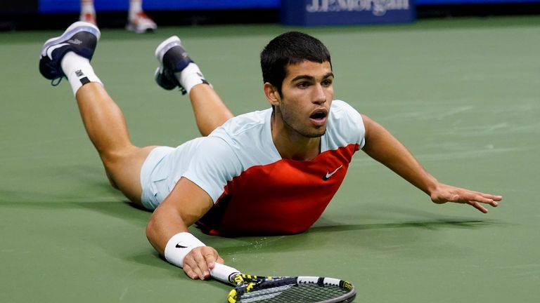Carlos Alcaraz, of Spain, falls to the court after chasing down a shot from Casper Ruud, of Norway, during the men's singles final of the U.S. Open tennis championships, Sunday, Sept. 11, 2022, in New York. (AP Photo/Charles Krupa)
