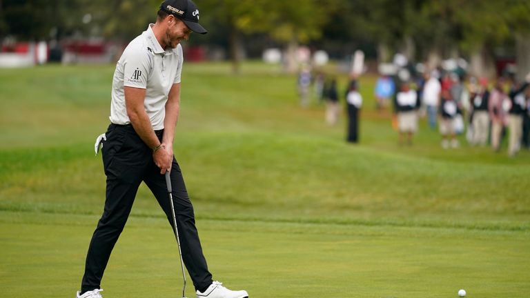 Willett reacts after missing a par putt on the 18th green