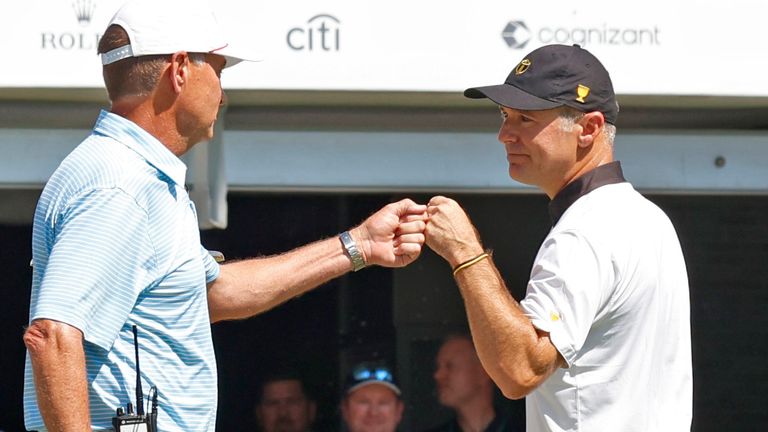 CHARLOTTE, NC - SEPTEMBER 22: USA Presidents Cup captain Davis Love III fist bumps International Presidents Cup captain Trevor Immelman during the opening ceremonies on September 22, 2022 at Quail Hollow Club in Charlotte, North Carolina. (Photo by Brian Spurlock/Icon Sportswire) (Icon Sportswire via AP Images)