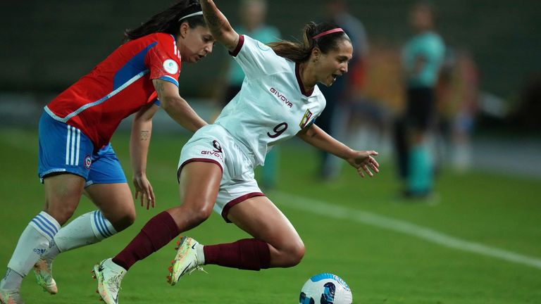 La venezolana Deyna Castellanos, a la derecha, y la chilena Karen Araya luchan por el balón durante un partido de fútbol de la Copa América en Armenia.