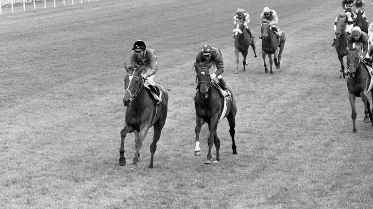 The Queen's horse Dunfermline, ridden by Willie Carson, just ahead of Freeze the Secret, ridden by Gianfranco Dettori, during an exciting finish to the Oaks at Epsom