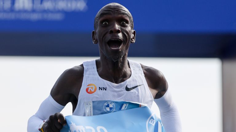 Kenya's Eliud Kipchoge crosses the line to win the Berlin Marathon in Berlin, Germany, Sunday, Sept. 25, 2022. Olympic champion Eliud Kipchoge has bettered his own world record in the Berlin Marathon. Kipchoge clocked 2:01:09 on Sunday to shave 30 seconds off his previous best-mark of 2:01:39 from the same course in 2018. (AP Photo/Christoph Soeder)