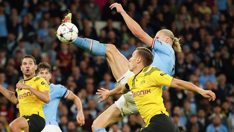 Manchester City's Erling Haaland, right, scores his team's second goal against Borussia Dortmund