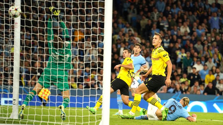 Manchester City's Erling Haaland, right on the pitch scores his side's 2nd goal during the group G Champions League soccer match between Manchester City and Borussia Dortmund at the Etihad stadium in Manchester, England, Wednesday, Sept. 14, 2022. (AP Photo/Dave Thompson)