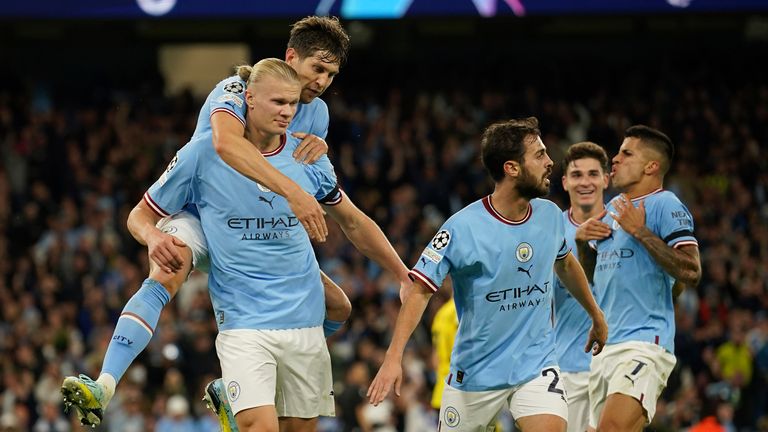 Manchester City's Erling Haaland, left, celebrates after scoring his side's winner vs Borussia Dortmund 