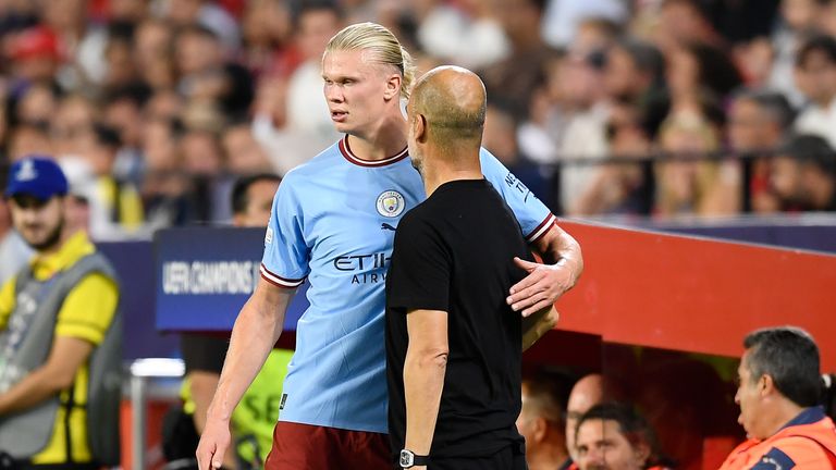 Manchester City's Erling Haaland stands on the touchline Guardiola