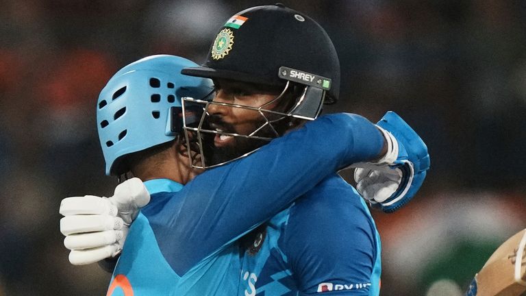 India's Hardik Pandya, right, hugs batting partner Dinesh Karthik to celebrate their win in the third T20 cricket match between India and Australia, in Hyderabad, India, Sunday, Sept. 25, 2022. (AP Photo/Mahesh Kumar A)