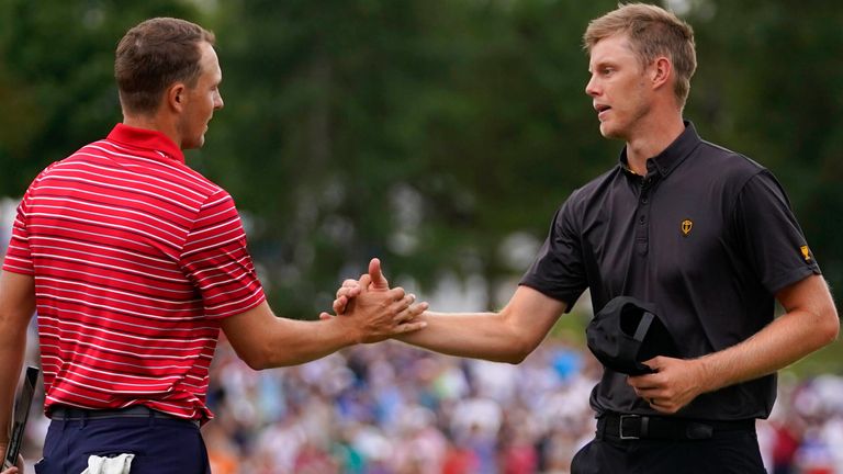 Jordan Spieth shakes hands with Cam Davis, of Australia, after Spieth took the hole during their singles match at the Presidents Cup golf tournament at the Quail Hollow Club, Sunday, Sept. 25, 2022, in Charlotte, N.C. (AP Photo/Julio Cortez)