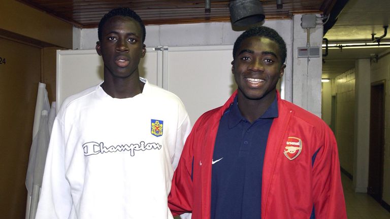 Yaya Toure and brother Kolo Toure pose for a photo before a friendly match between Belgian club Beveren and Arsenal in 2002.
