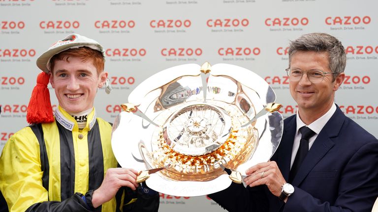 David Egan and Roger Varian lift the Cazoo St Leger trophy at Doncaster