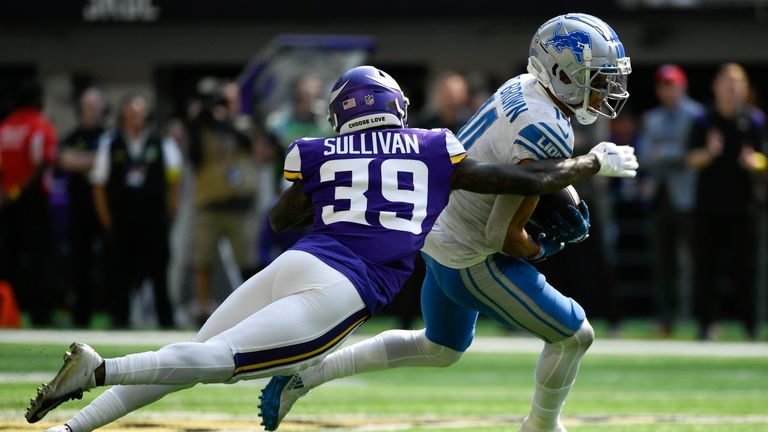 Detroit Lions wide receiver Amon-Ra St. Brown (14) runs from Minnesota Vikings cornerback Chandon Sullivan (39) after catching a pass during the second half of an NFL football game, Sunday, Sept. 25, 2022, in Minneapolis.