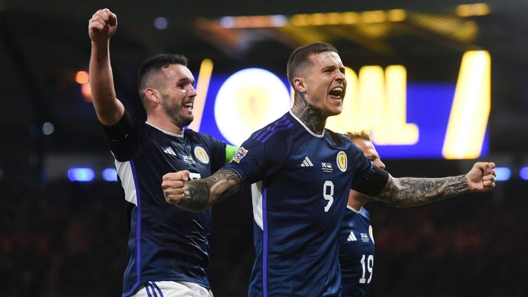 Scotland's Lyndon Dykes (R) celebrates with John McGinn   after making it 2-0 against Ukraine