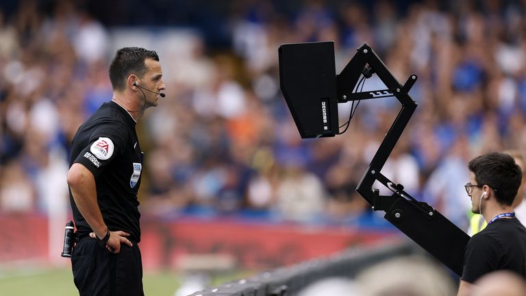 Referee Andy Madley checks the VAR monitor for the goal