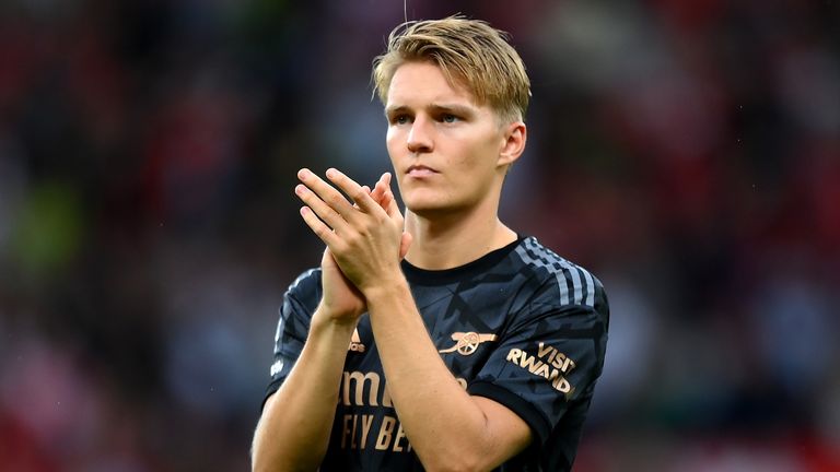 Martin Odegaard applauds the travelling fans following defeat at Old Trafford
