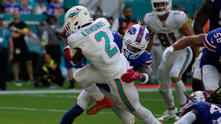 Miami Dolphins running back Chase Edmonds (2) scores a touchdown as Buffalo Bills safety Damar Hamlin (3) attempts to tackle him during the second half of an NFL football game, Sunday, Sept. 25, 2022, in Miami Gardens, Fla.