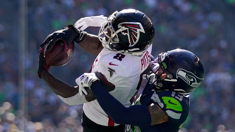 Atlanta Falcons tight end Kyle Pitts hauls in a pass as Seattle Seahawks safety Josh Jones defends during the first half of an NFL football game Sunday, Sept. 25, 2022, in Seattle. 