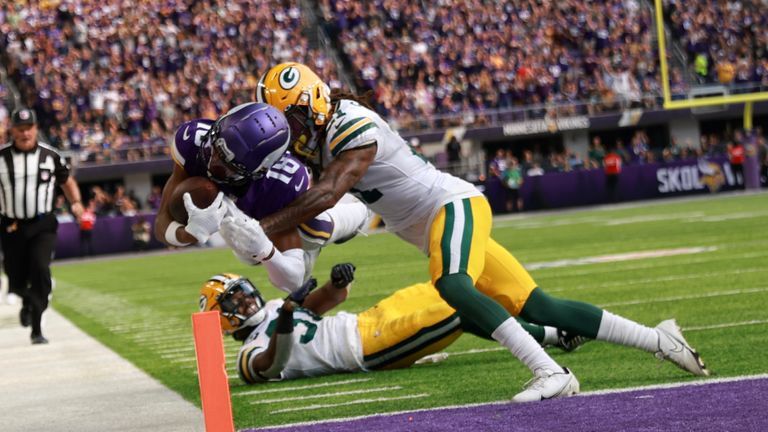 Minnesota Vikings wide receiver Justin Jefferson (18) scores on an 36-yard touchdown reception ahead of Green Bay Packers cornerback Eric Stokes (21) during the first half of an NFL football game, Sunday, Sept. 11, 2022, in Minneapolis. (AP Photo/Abbie Parr)


