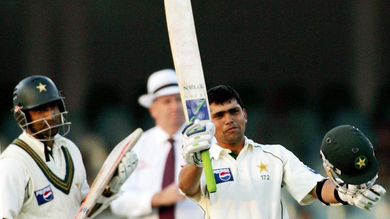 Pakistan batsman Kamal Akmal, right, raises his bat and helmet to response the supporters after complete his century against England as his teammate Mohammad Yousuf, left, looks on during the third day of third and final test match at Gaddafi Stadium in Lahore, Pakistan on Thursday, Dec. 1, 2005. (AP Photo/Anjum Naveed)


