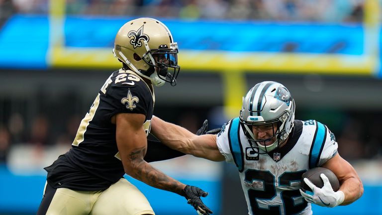 Carolina Panthers running back Christian McCaffrey (22) runs the ball against New Orleans Saints cornerback Marshon Lattimore (23) during the second half of an NFL football game, Sunday, Sept. 25, 2022, in Charlotte, N.C.