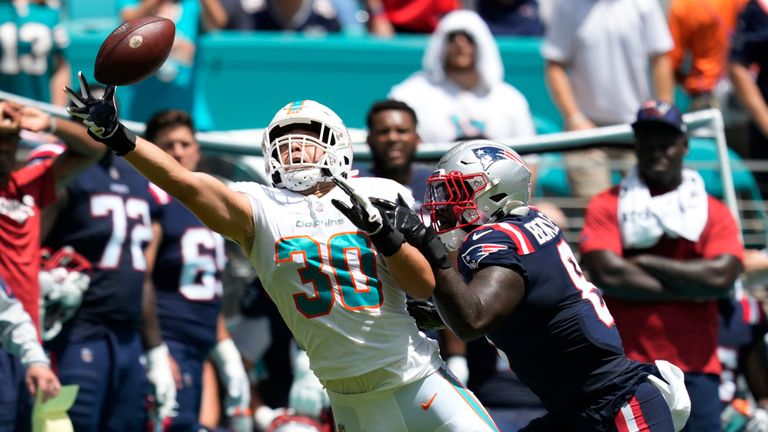 Miami Dolphins fullback Alec Ingold (30) is unable to make the catch under pressure from New England Patriots wide receiver Kendrick Bourne (84) during the first half of an NFL football game, Sunday, Sept. 11, 2022, in Miami Gardens, Fla. (AP Photo/Rebecca Blackwell)


