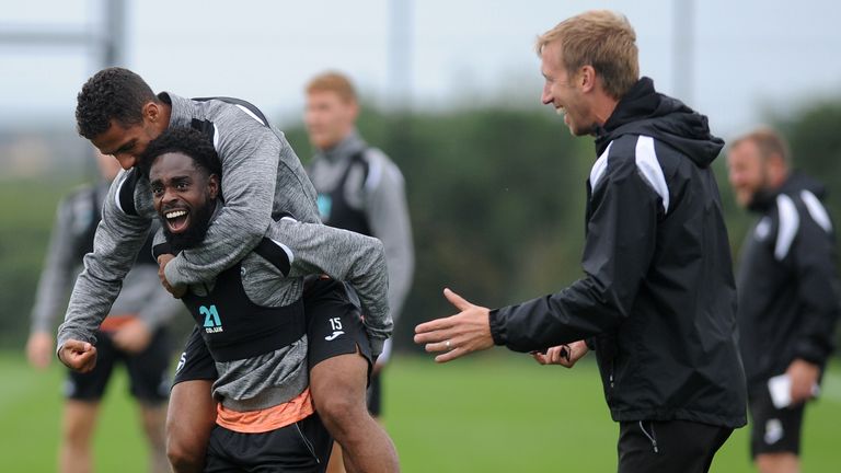 Swansea City&#39;s Nathan Dyer and Wayne Routledge joke while watched by manager Graham Potter during the Swansea City Training at The Fairwood Training Ground on August 14, 2018 in Swansea, Wales. 